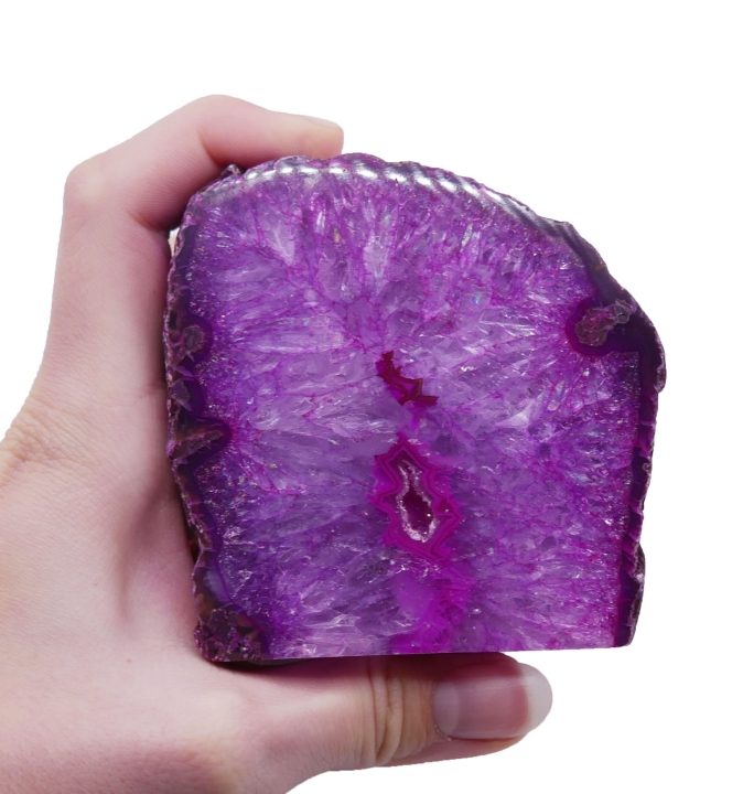 Surowa bryłka różowego agatu z jedną polerowaną ścianą i płaską podstawą na białym tle.