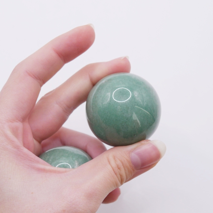 Zbliżenie na strukturę kuli z awenturynu, widoczne subtelne, mieniące się drobiny.