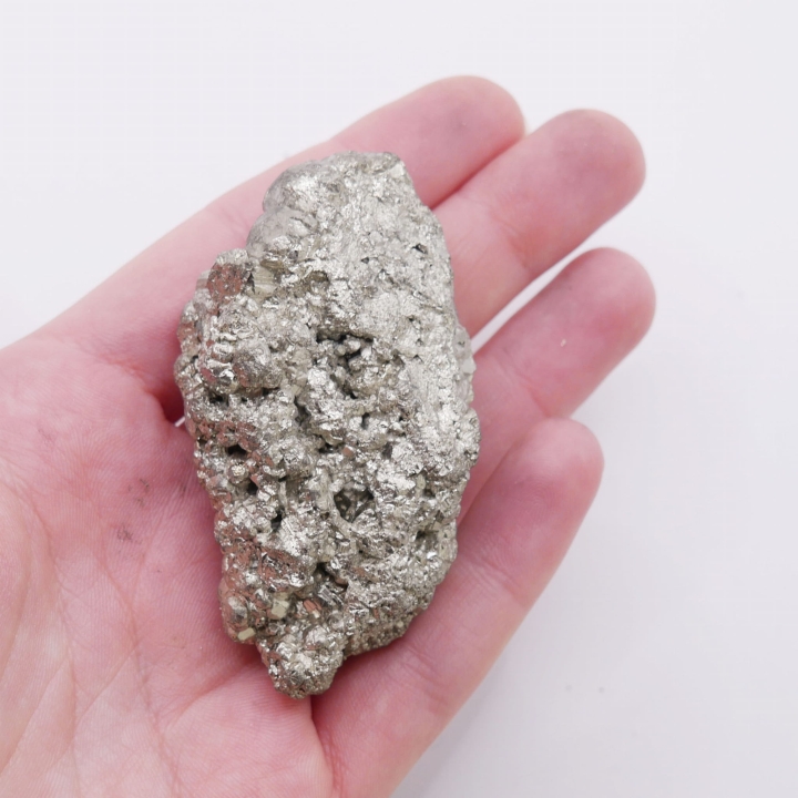 Zbliżenie na metaliczny połysk i złotą barwę naturalnego pirytu.